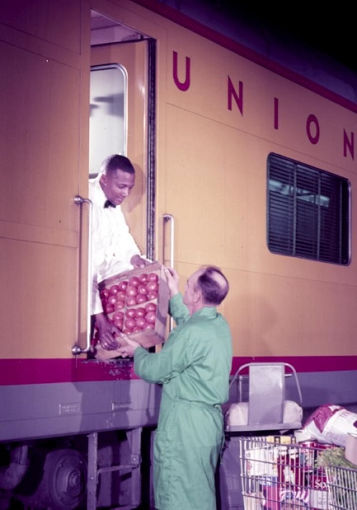 <p>UP employee loading diner lounge car No. 5003 c. 1950.</p>
