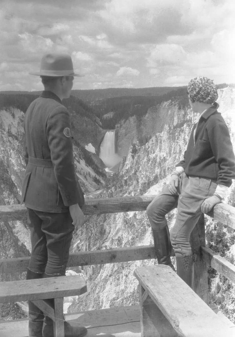 Ranger Frank Sissby and Julie Pressen of Chicago, Illinois, view the Lower Falls of the Yellowstone River and Grand Canyon of the Yellowstone